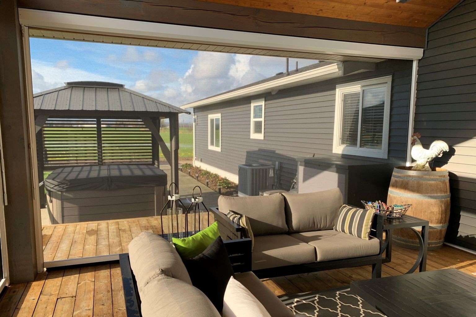 Outdoor living space with retractable shade products installed